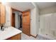 Bright bathroom featuring a shower, toilet, and a white sink with a natural wood base cabinet at 7333 State Road 42, Martinsville, IN 46151