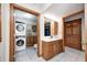 Bathroom includes a stackable washer and dryer and natural wood vanity with white sink at 7333 State Road 42, Martinsville, IN 46151