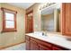 Bathroom featuring wood cabinets, a white countertop, and a window at 7333 State Road 42, Martinsville, IN 46151