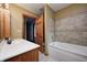 Well-lit bathroom with tiled shower over tub and neutral color palette at 7333 State Road 42, Martinsville, IN 46151