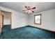 Bright bedroom featuring blue carpet, window, and doorway at 7333 State Road 42, Martinsville, IN 46151