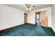 The primary bedroom features neutral walls, carpet flooring, ceiling fan, and wooden trim at 7333 State Road 42, Martinsville, IN 46151