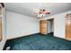 Bedroom featuring green carpet, ceiling fan, and an open closet space at 7333 State Road 42, Martinsville, IN 46151