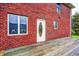 Rear exterior view of brick home featuring a deck and entry door with decorative glass at 7333 State Road 42, Martinsville, IN 46151