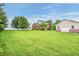Charming two-story brick home with a well-maintained lawn, mature trees, and a detached garage at 7333 State Road 42, Martinsville, IN 46151