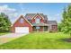 Beautiful two-story brick home featuring a well-manicured lawn and attached garage at 7333 State Road 42, Martinsville, IN 46151