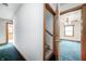 View of hallway leading to bedroom with stairs and a decorative door frame at 7333 State Road 42, Martinsville, IN 46151