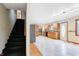 Open layout showcasing a staircase and spacious kitchen featuring wood cabinetry and tile floors at 7333 State Road 42, Martinsville, IN 46151