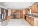 Well-maintained kitchen with stainless steel refrigerator and appliances, wood cabinets, and tile floor at 7333 State Road 42, Martinsville, IN 46151