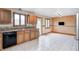 Kitchen with oak cabinets, a double sink under a window, and tile flooring at 7333 State Road 42, Martinsville, IN 46151