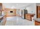 Open-concept kitchen with stainless steel refrigerator and tile flooring open to dining area at 7333 State Road 42, Martinsville, IN 46151