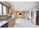 Spacious kitchen with oak cabinets, a double sink under a window, and tile flooring at 7333 State Road 42, Martinsville, IN 46151