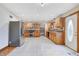 Well-lit kitchen featuring wood cabinets, stainless steel appliances, tile floor, and plenty of storage space at 7333 State Road 42, Martinsville, IN 46151