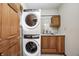 Stackable laundry unit with washer and dryer featuring cabinetry, sink and countertops at 7333 State Road 42, Martinsville, IN 46151