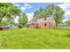 Spacious backyard featuring a lush lawn, mature trees, and a charming gazebo at 7633 Janean Dr, Brownsburg, IN 46112