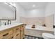 Elegant bathroom featuring a soaking tub, designer tile, and stylish vanity at 7633 Janean Dr, Brownsburg, IN 46112