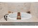 Luxurious soaking tub with tile surround and convenient bath caddy at 7633 Janean Dr, Brownsburg, IN 46112