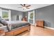 Cozy bedroom with natural light, wood floors, and comfortable furnishings at 7633 Janean Dr, Brownsburg, IN 46112