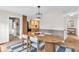 Dining area featuring wood table, rug, and adjacent view of the kitchen at 7633 Janean Dr, Brownsburg, IN 46112