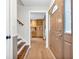Welcoming entryway with stairs and hardwood floors that leads into the kitchen at 7633 Janean Dr, Brownsburg, IN 46112