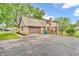 Home exterior with a brick and siding finish, an attached garage, and mature landscaping at 7633 Janean Dr, Brownsburg, IN 46112