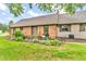 Inviting exterior showcasing the brick facade, manicured landscaping, and quaint flower boxes at 7633 Janean Dr, Brownsburg, IN 46112