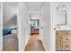 Hallway with wood floors and views into the bedroom and bathroom at 7633 Janean Dr, Brownsburg, IN 46112