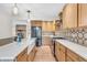 Spacious kitchen features stainless steel appliances, a center island, and stylish backsplash at 7633 Janean Dr, Brownsburg, IN 46112