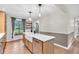 Bright kitchen showcasing a large island sink and adjacent view to the window at 7633 Janean Dr, Brownsburg, IN 46112