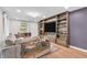 Cozy living room with custom built-in shelving, hardwood floors, and comfortable seating at 7633 Janean Dr, Brownsburg, IN 46112