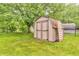 Backyard shed with wooden exterior and secure double doors, providing extra storage at 7633 Janean Dr, Brownsburg, IN 46112
