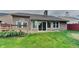 The backyard features a deck, a well-maintained lawn, and mature landscaping, offering a serene outdoor space at 7859 Chesapeake E Dr, Indianapolis, IN 46236