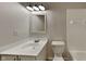 Bright bathroom with a vanity, mirror, updated lighting, and a shower-tub combination at 7859 Chesapeake E Dr, Indianapolis, IN 46236