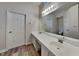 Bathroom boasts dual sinks, updated vanity, and large mirror at 7859 Chesapeake E Dr, Indianapolis, IN 46236