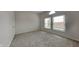 Bright, neutral bedroom with two windows and carpet flooring at 7859 Chesapeake E Dr, Indianapolis, IN 46236