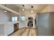 Modern kitchen with stainless steel appliances, white cabinets, and an eat-in counter at 7859 Chesapeake E Dr, Indianapolis, IN 46236