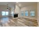 Open living room features vaulted ceilings, wood floors, and a cozy fireplace at 7859 Chesapeake E Dr, Indianapolis, IN 46236