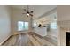 Bright living room featuring vaulted ceilings, wood floors, fireplace, and open kitchen view at 7859 Chesapeake E Dr, Indianapolis, IN 46236