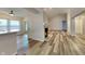 Spacious living room offers wood floors, large windows, and view into open kitchen at 7859 Chesapeake E Dr, Indianapolis, IN 46236