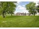 Exterior of home featuring backyard with mature shade trees at 7990 S County Road 200 E, Pittsboro, IN 46167