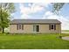 Home exterior showcasing the backyard with a lawn and a sliding glass door at 7990 S County Road 200 E, Pittsboro, IN 46167