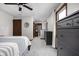 Spacious bedroom with ceiling fan, neutral walls, and a view into the en-suite bathroom at 7990 S County Road 200 E, Pittsboro, IN 46167
