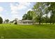 Inviting single-story home with a well-manicured lawn and a welcoming front porch, ideal for relaxation at 7990 S County Road 200 E, Pittsboro, IN 46167