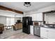 Open concept: Kitchen with black refrigerator looks into the living room at 7990 S County Road 200 E, Pittsboro, IN 46167