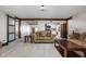 Spacious living room features wood beams, neutral colors, and seamlessly connects to other rooms at 7990 S County Road 200 E, Pittsboro, IN 46167