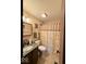 Traditional bathroom with floral curtain, and neutral accents, providing a tranquil and comfortable space at 8123 Summertree Ct, Indianapolis, IN 46256