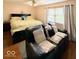 Bedroom with cozy seating, hardwood floors, and bright window for natural light at 8123 Summertree Ct, Indianapolis, IN 46256