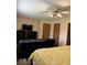 Comfortable bedroom featuring a cozy recliner, large television, and neutral color scheme at 8123 Summertree Ct, Indianapolis, IN 46256