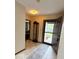 Entryway featuring neutral tiling, an open door, and view into an adjacent living space at 8123 Summertree Ct, Indianapolis, IN 46256
