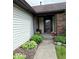 Inviting front porch adorned with charming plants and landscaping at 8123 Summertree Ct, Indianapolis, IN 46256